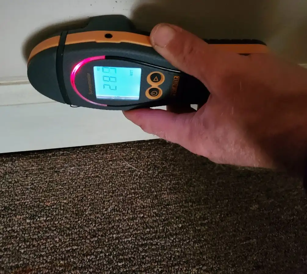 Moisture detection at baseboard during Storm Damage Restoration in Lago Vista